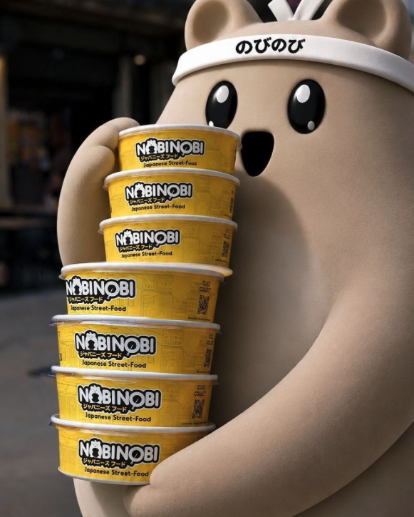 La mascotte Nobi Nobi portant les bols jaunes de la marque